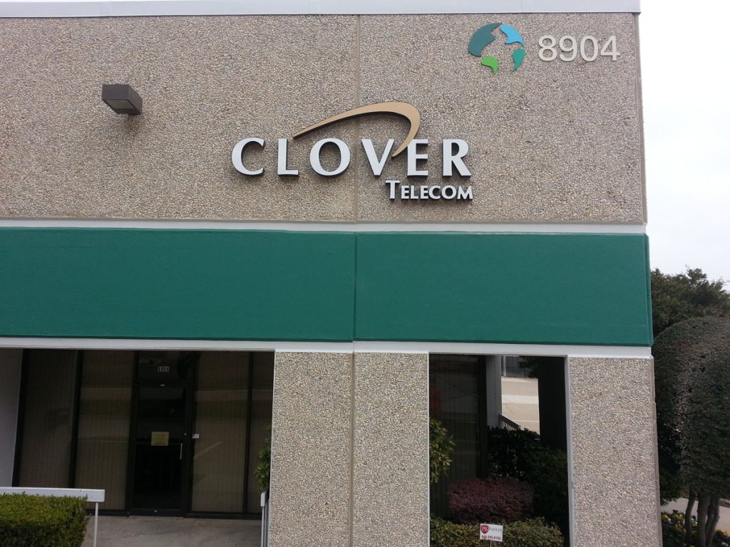 Exterior building sign for Clover Telecom business in Dallas, TX