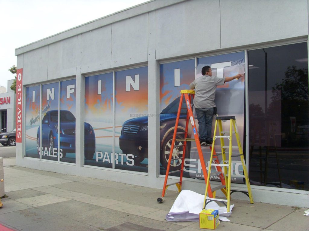 Installing storefront window graphics for sale by Priority Signs & Graphics in Dallas, TX