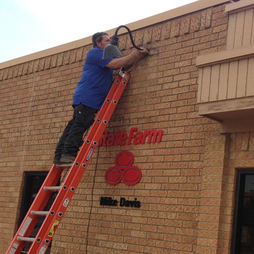 Sign experts installing custom signage in DFW