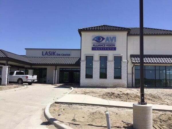 Installing Eye Center and AVI sign by Priority Signs & Graphics in Dallas, TX