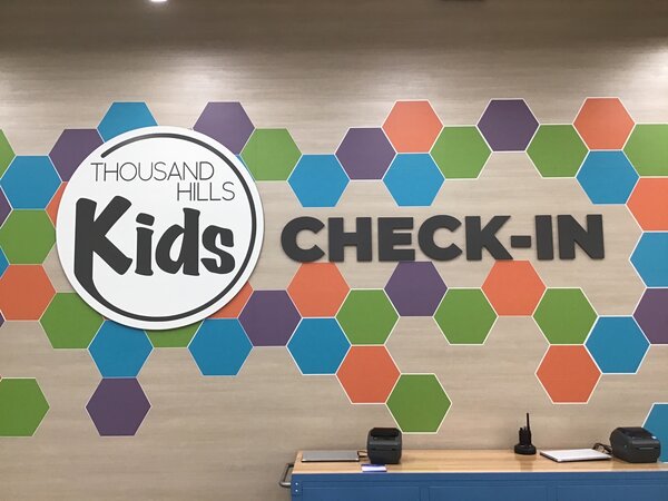 Custom office lobby sign of Thousand Hill Kids in Dallas
