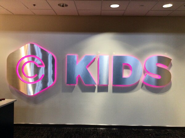 Lighted lobby sign & logo of kids made by Priority Signs & Graphics in Dallas, TX