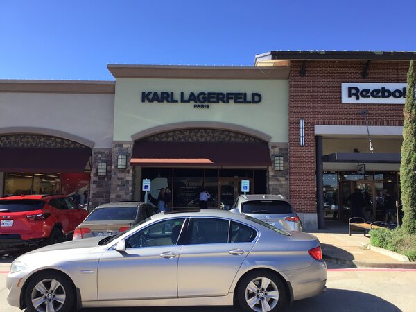 Storefront business sign of Karl Langerfeld installed in DFW
